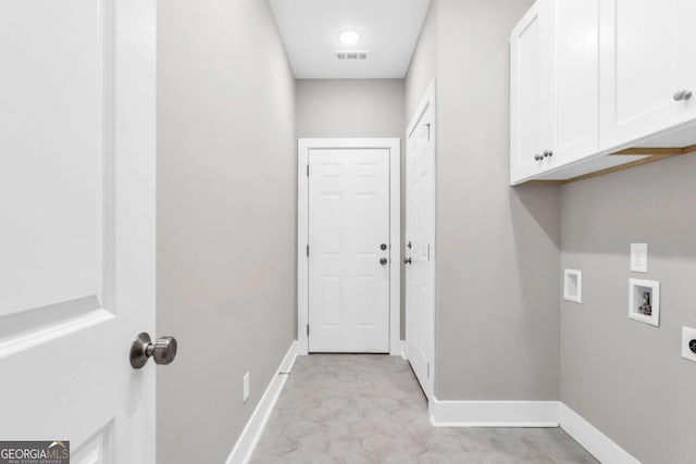washroom with visible vents, baseboards, hookup for a washing machine, cabinet space, and hookup for an electric dryer