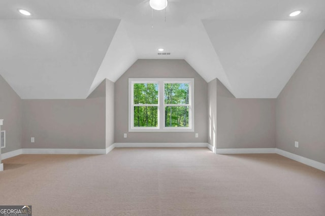 bonus room featuring baseboards, lofted ceiling, carpet flooring, and visible vents