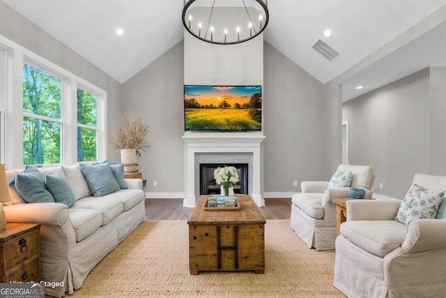 living room featuring recessed lighting, high vaulted ceiling, visible vents, and wood finished floors