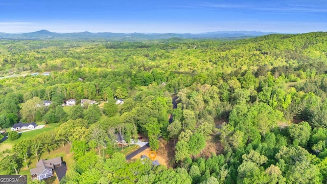 bird's eye view with a wooded view and a mountain view