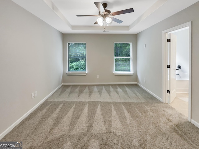6001 Oak Bend Ct, Riverdale, GA 30296 - spare room with a raised ceiling, carpet, and ceiling fan