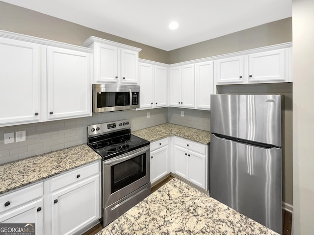 6001 Oak Bend Ct, Riverdale, GA 30296 - kitchen featuring stainless steel appliances, white cabinetry, tasteful backsplash, light stone countertops, and recessed lighting
