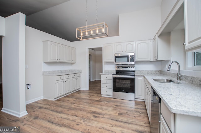 kitchen featuring white cabinetry, appliances with stainless steel finishes, and a sink