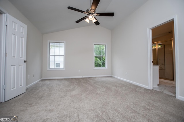 unfurnished bedroom with carpet floors, baseboards, and vaulted ceiling