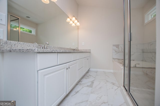 bathroom with an inviting chandelier, a marble finish shower, a healthy amount of sunlight, and marble finish floor