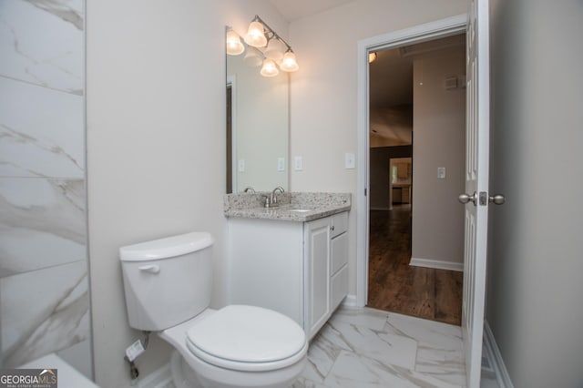 bathroom featuring vanity, marble finish floor, and toilet