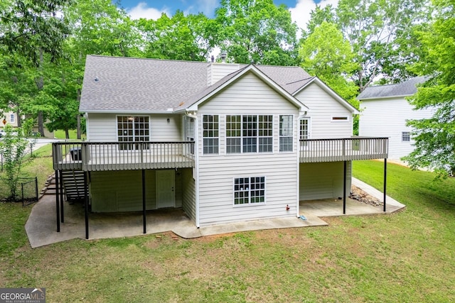 rear view of house featuring a wooden deck, a shingled roof, a patio area, a yard, and stairway