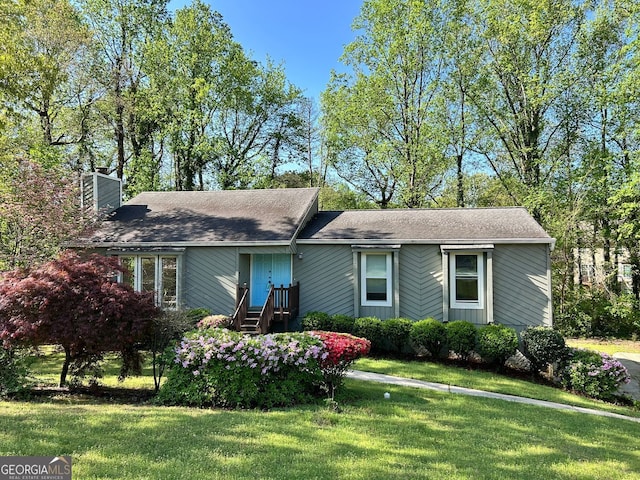 ranch-style house with a front lawn and a chimney