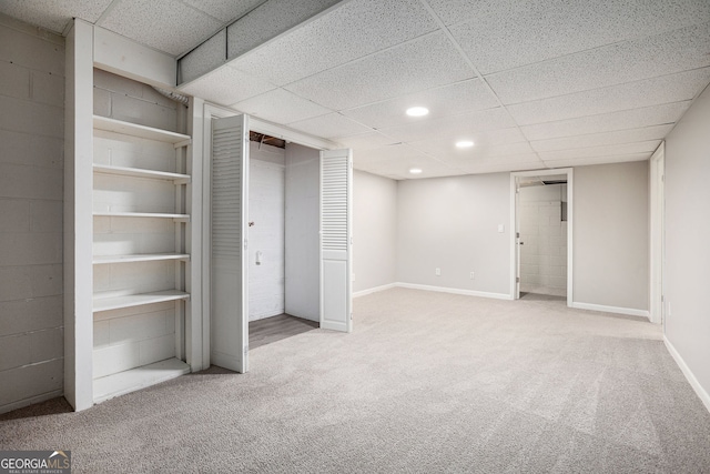 unfurnished bedroom with carpet floors, recessed lighting, a paneled ceiling, and baseboards