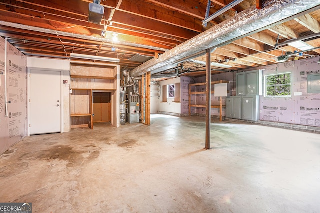 basement featuring water heater and electric panel