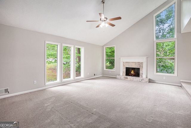 unfurnished living room featuring carpet flooring, baseboards, visible vents, and ceiling fan