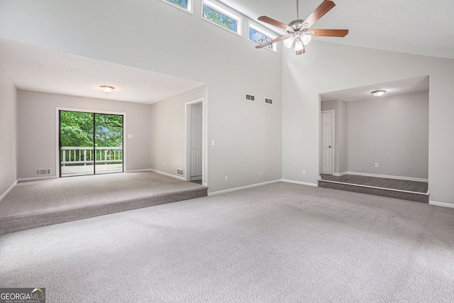 unfurnished living room with plenty of natural light, carpet flooring, and visible vents