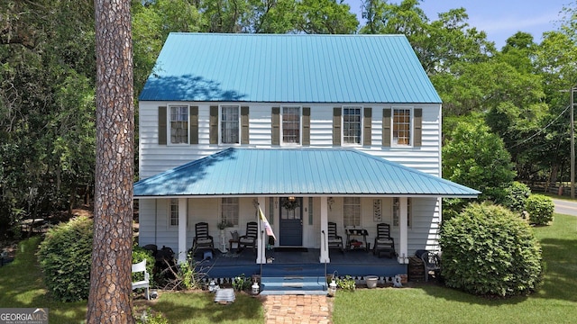 701 N Oak St, Springfield, GA 31329 - view of front of home with covered porch, metal roof, and a front lawn