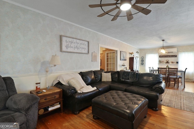 701 N Oak St, Springfield, GA 31329 - living room with ornamental molding, ceiling fan, wood finished floors, and a wainscoted wall