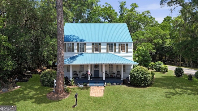 701 N Oak St, Springfield, GA 31329 - view of front of home with a porch, metal roof, and a front lawn