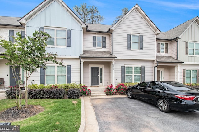 7762 Fawn Cir, Covington, GA 30014 - view of property with board and batten siding and a front yard