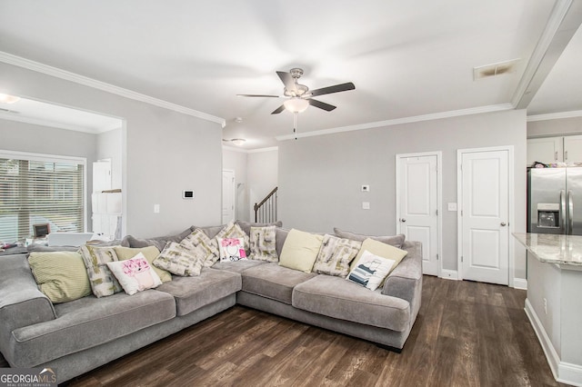 7762 Fawn Cir, Covington, GA 30014 - living room featuring a ceiling fan, dark wood finished floors, stairs, and crown molding