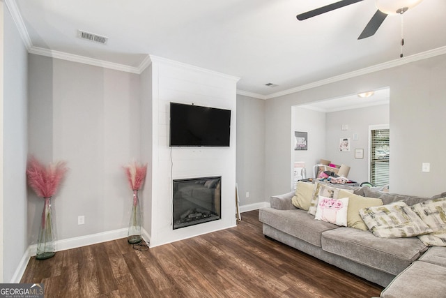 7762 Fawn Cir, Covington, GA 30014 - living room featuring dark wood-style floors, ceiling fan, crown molding, and a fireplace