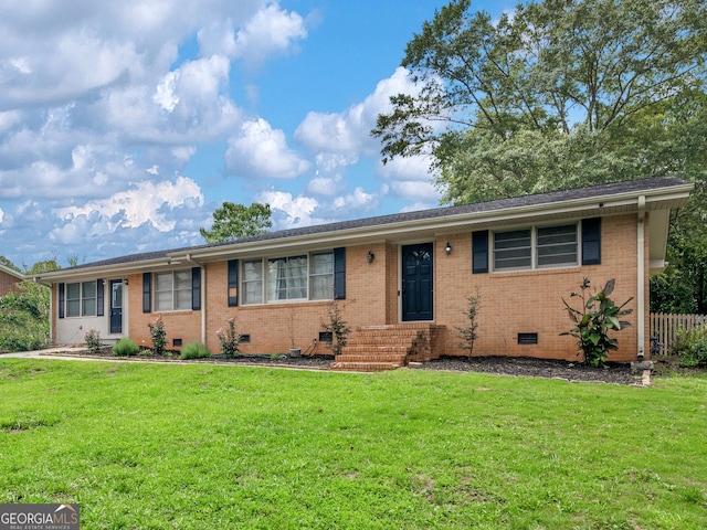 ranch-style home with brick siding, a front yard, and crawl space