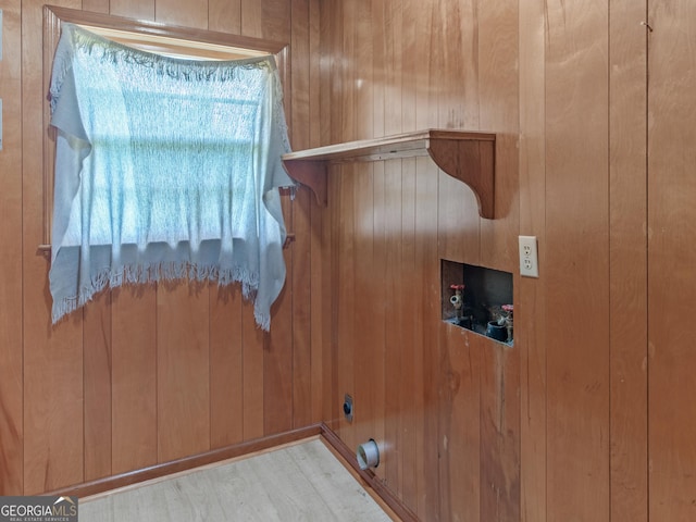 laundry room with laundry area, wood walls, and hookup for a washing machine