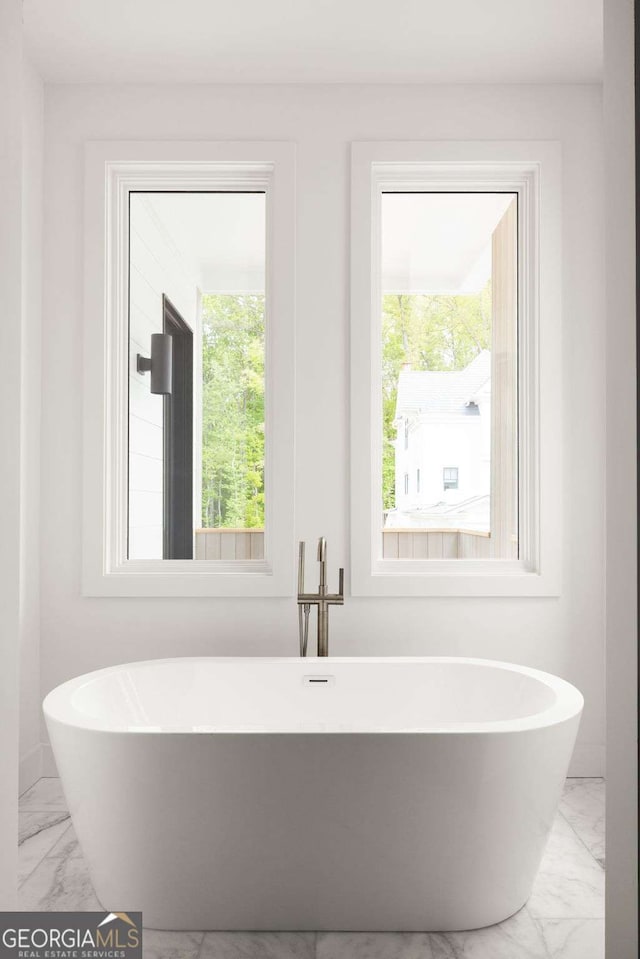 11542 Serenbe Ln, Chattahoochee Hills, GA 30268 - bathroom featuring a soaking tub and marble finish floor