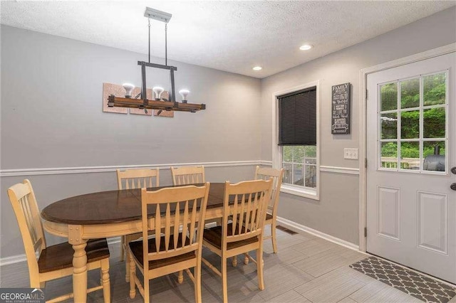 204 Queensbury Ct, Acworth, GA 30102 - dining room featuring baseboards, a notable chandelier, a textured ceiling, and a wealth of natural light