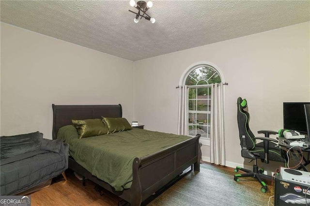 204 Queensbury Ct, Acworth, GA 30102 - bedroom with a textured ceiling, baseboards, and wood finished floors