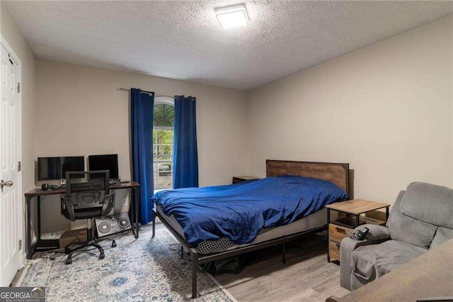 204 Queensbury Ct, Acworth, GA 30102 - bedroom with a textured ceiling and wood finished floors