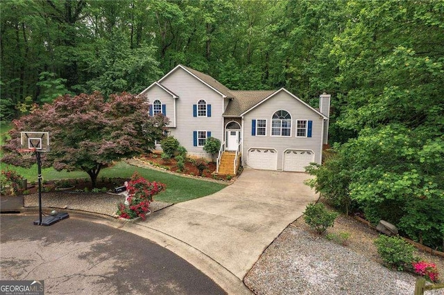 204 Queensbury Ct, Acworth, GA 30102 - view of front of home featuring a chimney, an attached garage, and driveway