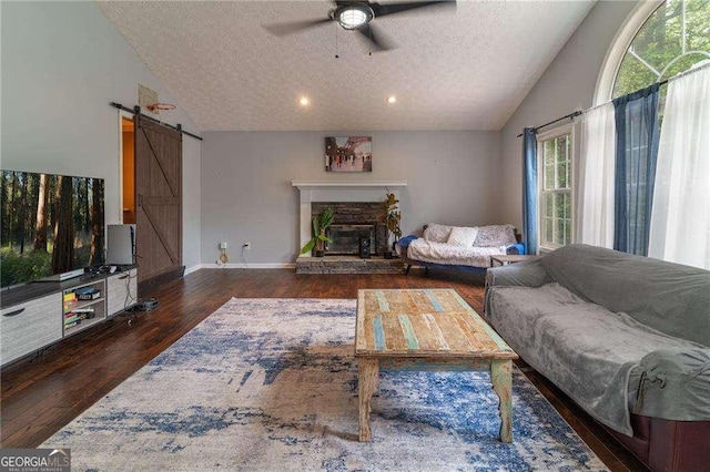 204 Queensbury Ct, Acworth, GA 30102 - living area featuring a ceiling fan, a textured ceiling, a barn door, wood finished floors, and lofted ceiling