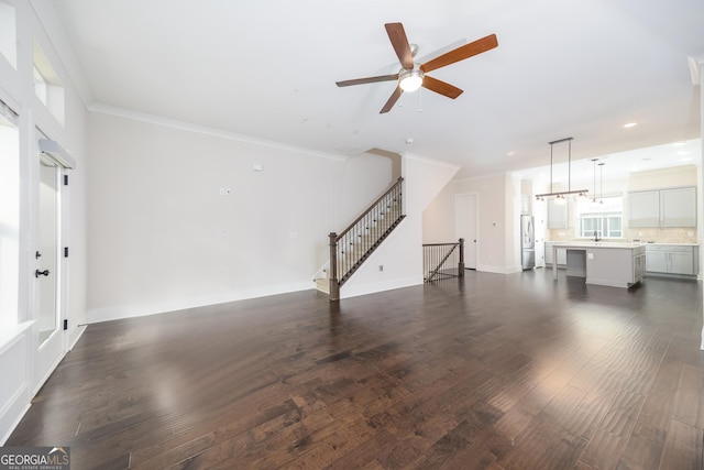 915 Katie Kerr Dr, Decatur, GA 30030 - unfurnished living room with crown molding, baseboards, dark wood-type flooring, recessed lighting, and a ceiling fan