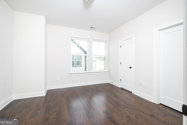 915 Katie Kerr Dr, Decatur, GA 30030 - unfurnished room featuring baseboards, dark wood finished floors, and visible vents