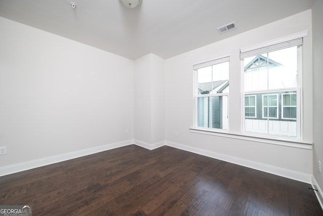 915 Katie Kerr Dr, Decatur, GA 30030 - empty room with visible vents, dark wood-style flooring, and baseboards