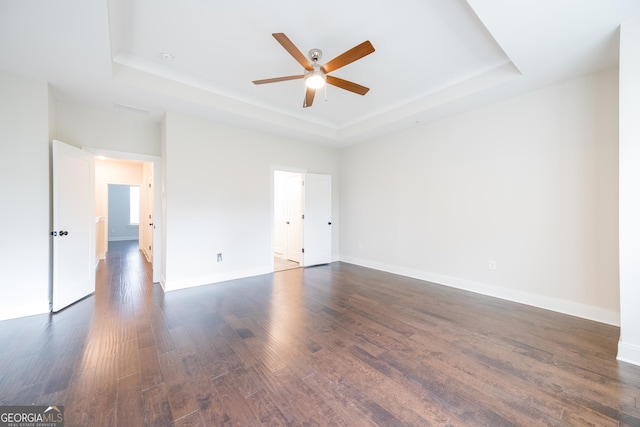 915 Katie Kerr Dr, Decatur, GA 30030 - spare room featuring a raised ceiling, baseboards, a ceiling fan, and dark wood finished floors