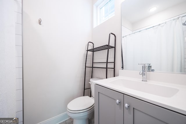 915 Katie Kerr Dr, Decatur, GA 30030 - bathroom with baseboards, toilet, and vanity