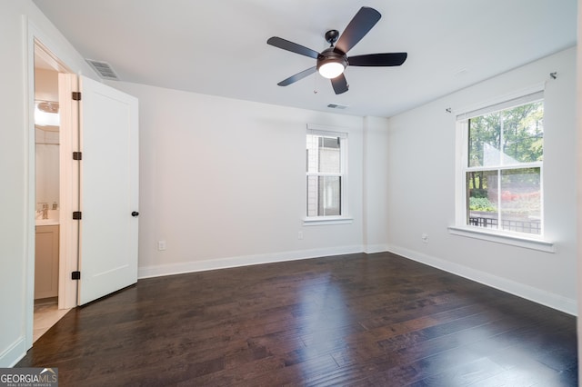 915 Katie Kerr Dr, Decatur, GA 30030 - spare room featuring dark wood-style flooring, ceiling fan, visible vents, and baseboards
