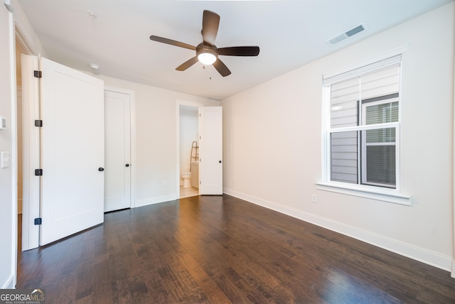 915 Katie Kerr Dr, Decatur, GA 30030 - unfurnished bedroom with ceiling fan, visible vents, baseboards, ensuite bath, and dark wood-type flooring