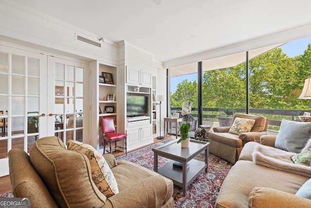 2660 Peachtree Rd Unit 7F, Atlanta, GA 30305 - living room featuring floor to ceiling windows, french doors, visible vents, wood finished floors, and ornamental molding