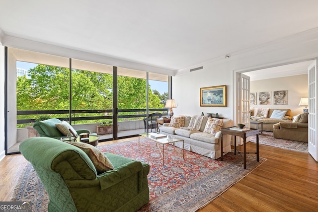 2660 Peachtree Rd Unit 7F, Atlanta, GA 30305 - living room featuring crown molding, floor to ceiling windows, wood finished floors, and visible vents