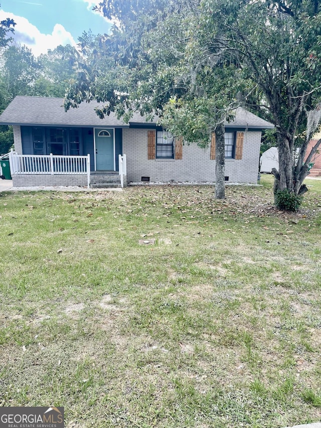 single story home with covered porch, a front lawn, and brick siding