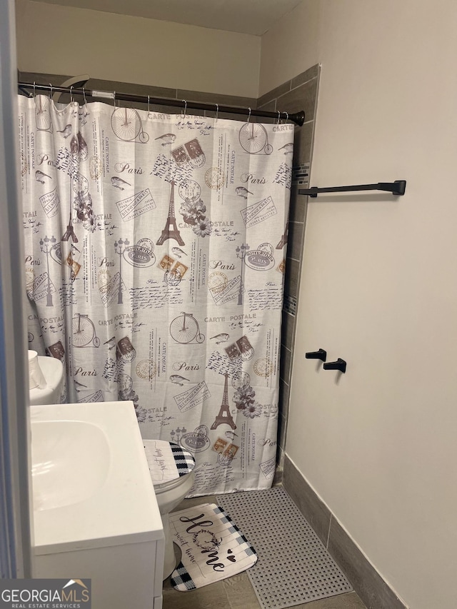 full bath featuring toilet, a shower with shower curtain, tile patterned flooring, and vanity