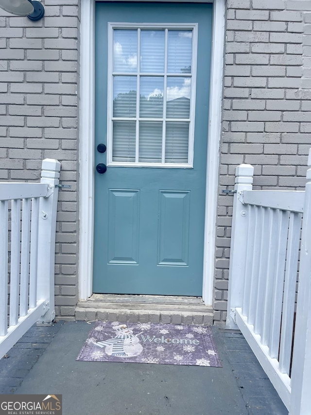 property entrance with brick siding