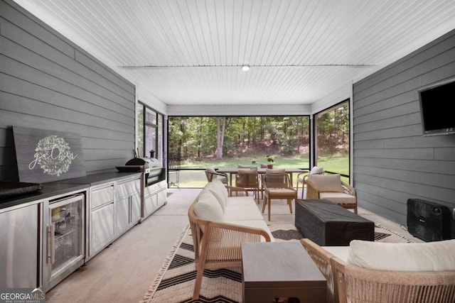view of patio with covered porch, beverage cooler, area for grilling, an outdoor living space, and an outdoor kitchen