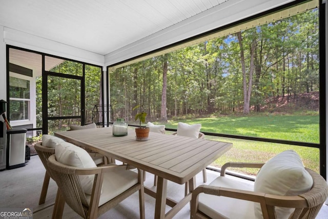 sunroom with outdoor dining area