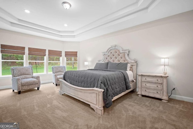 bedroom with carpet floors, recessed lighting, a raised ceiling, and baseboards