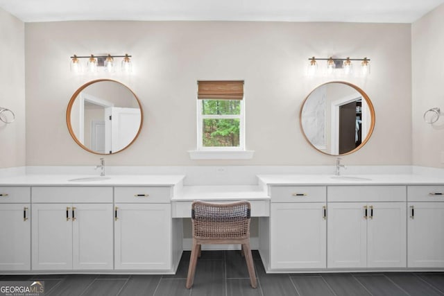 bathroom with two vanities, a sink, and tile patterned flooring