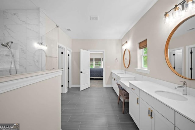 ensuite bathroom featuring visible vents, walk in shower, vanity, baseboards, and connected bathroom