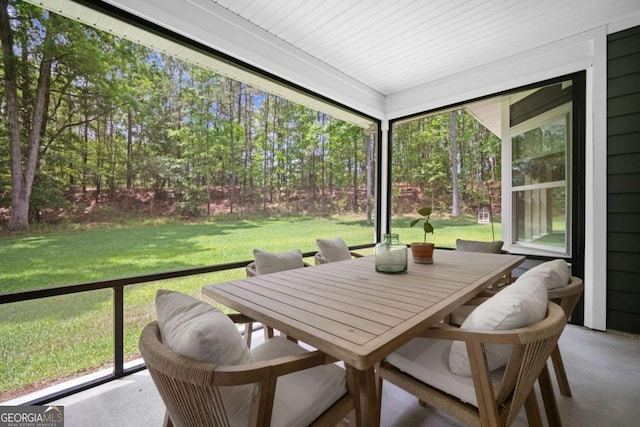 sunroom / solarium featuring outdoor dining space