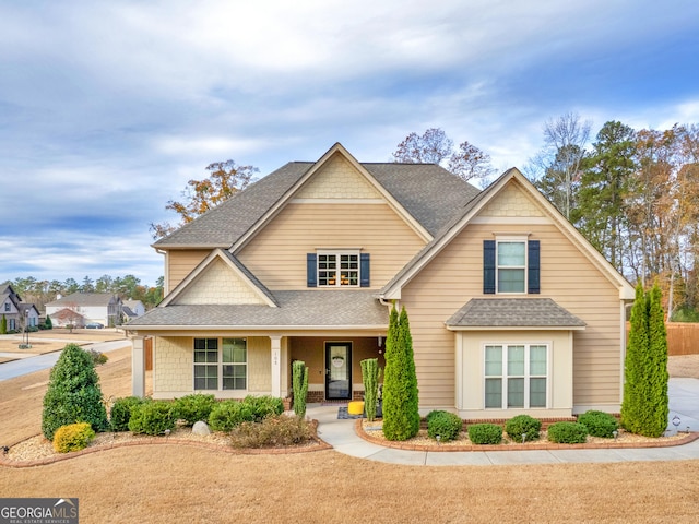 view of front of property with covered porch and a shingled roof