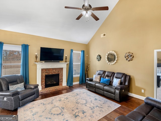 living room with visible vents, dark wood-style flooring, baseboards, high vaulted ceiling, and a ceiling fan